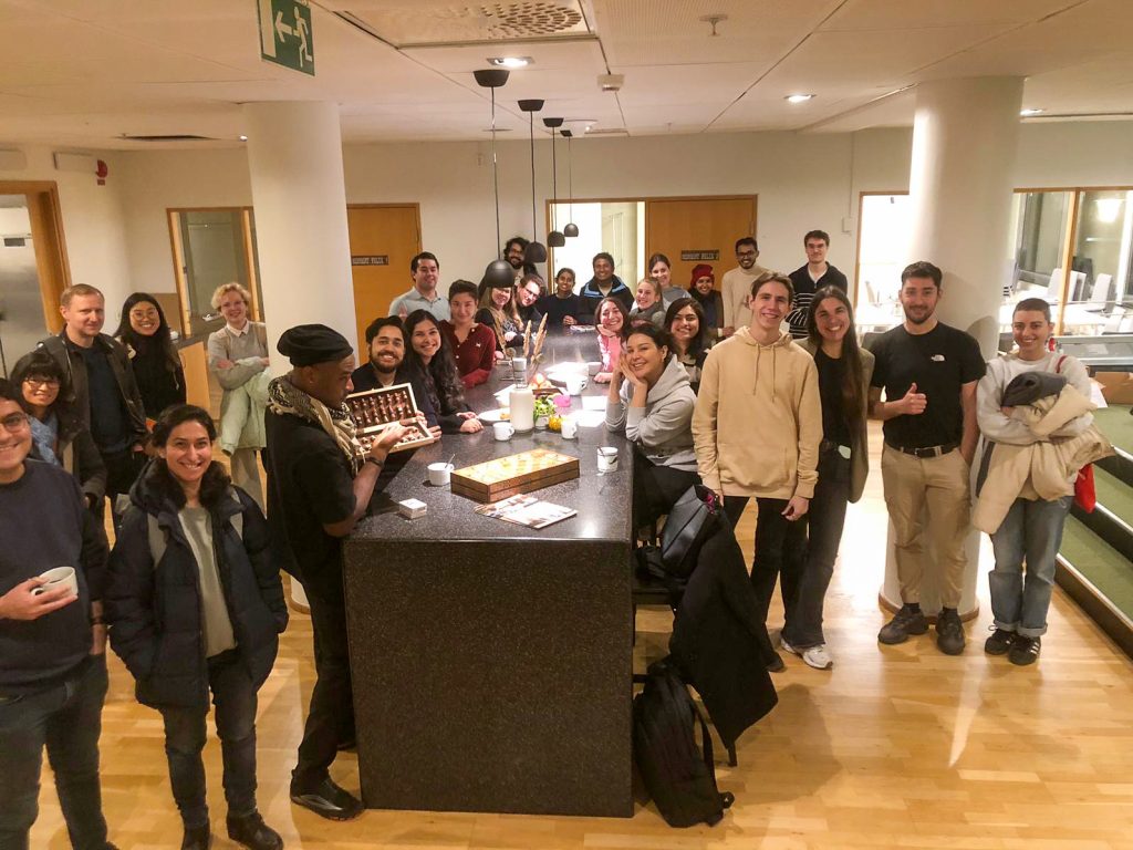 a large group of students gathered around a long table